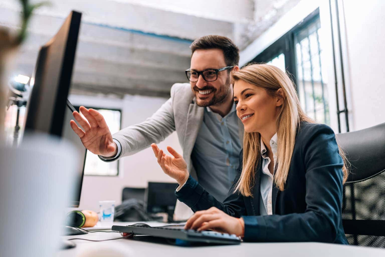 Image of two people looking at a computer Image of two people looking at a computer