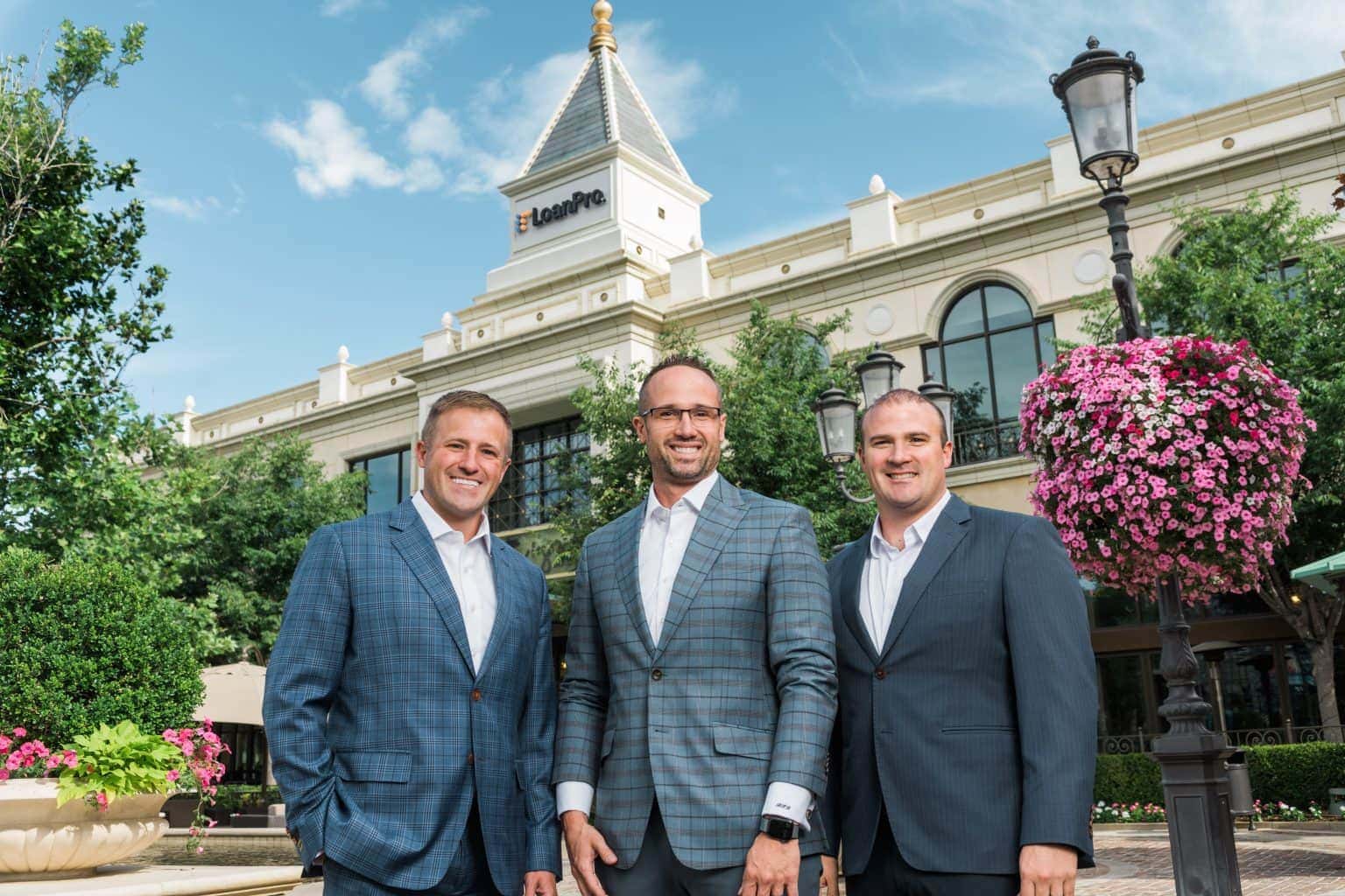 Image of the three founders of LoanPro in front of the headquarters Image of the three founders of LoanPro in front of the headquarters